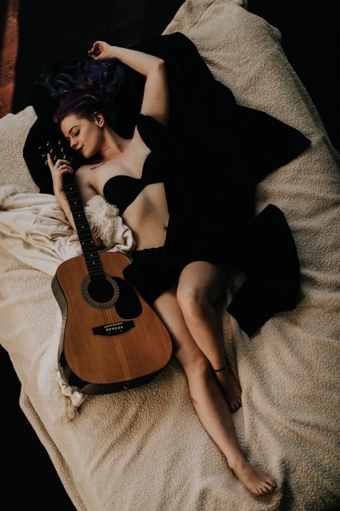 dark and moody boudoir with a guitar
