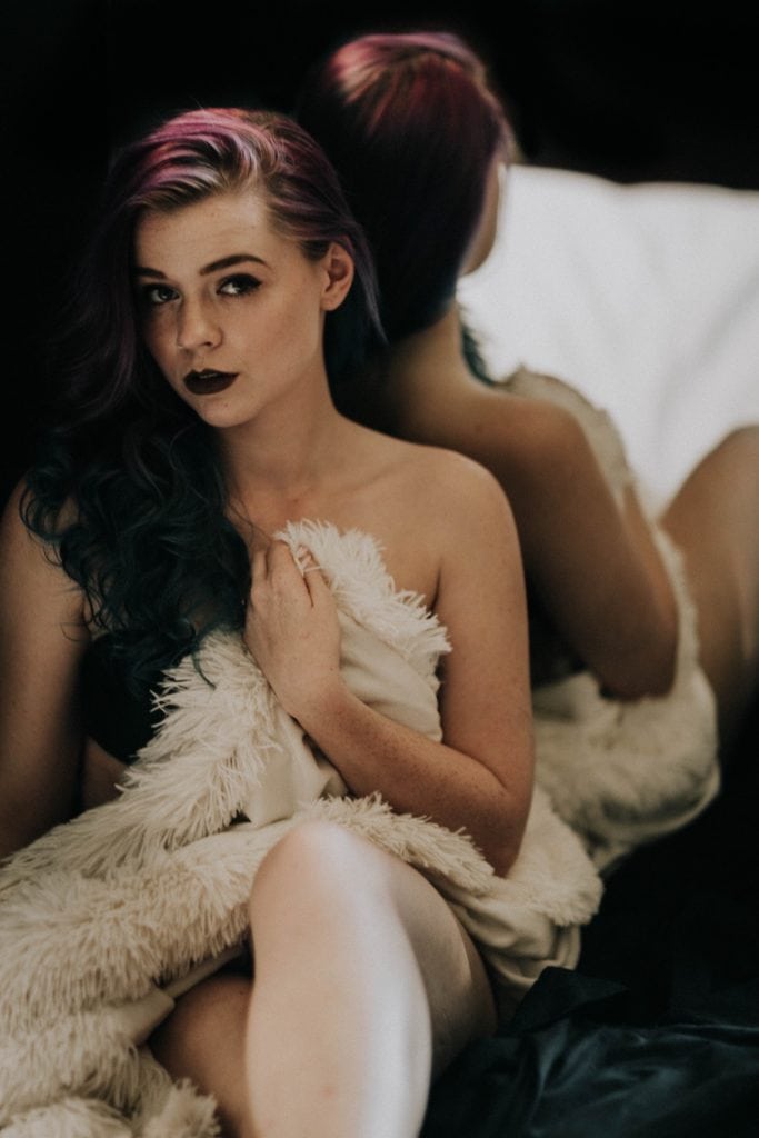 dark and moody boudoir photos in front of a mirror