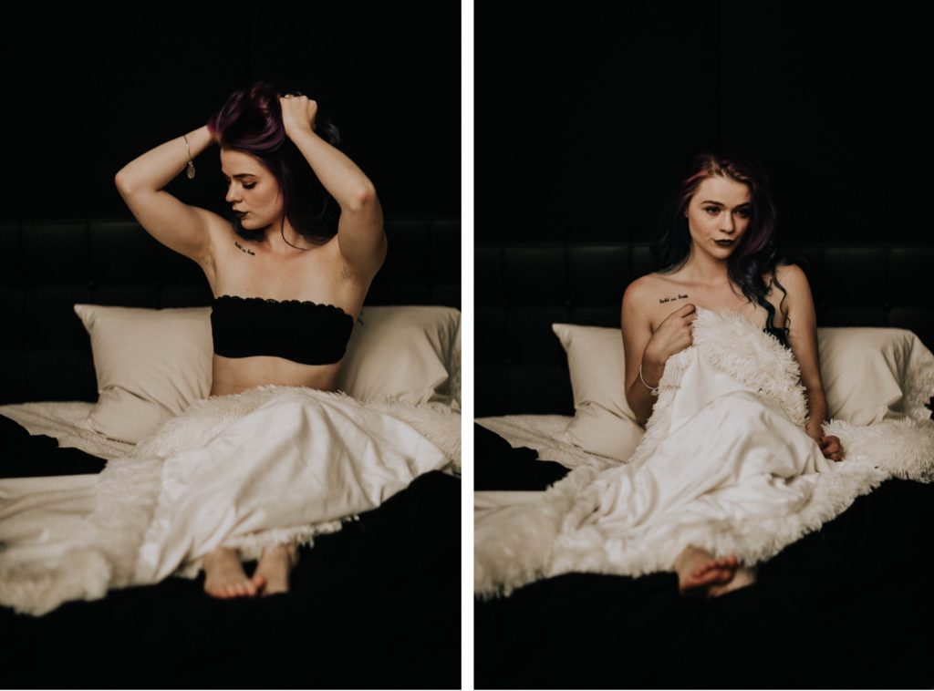 woman tousling her hair during moody boudoir session