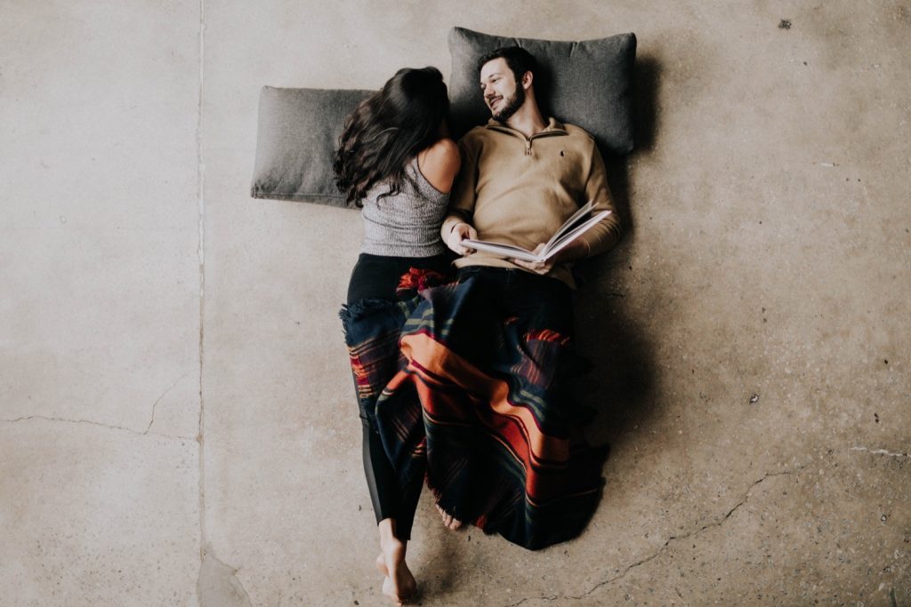 engaged couple snuggling up with each other during their at-home engagement photos
