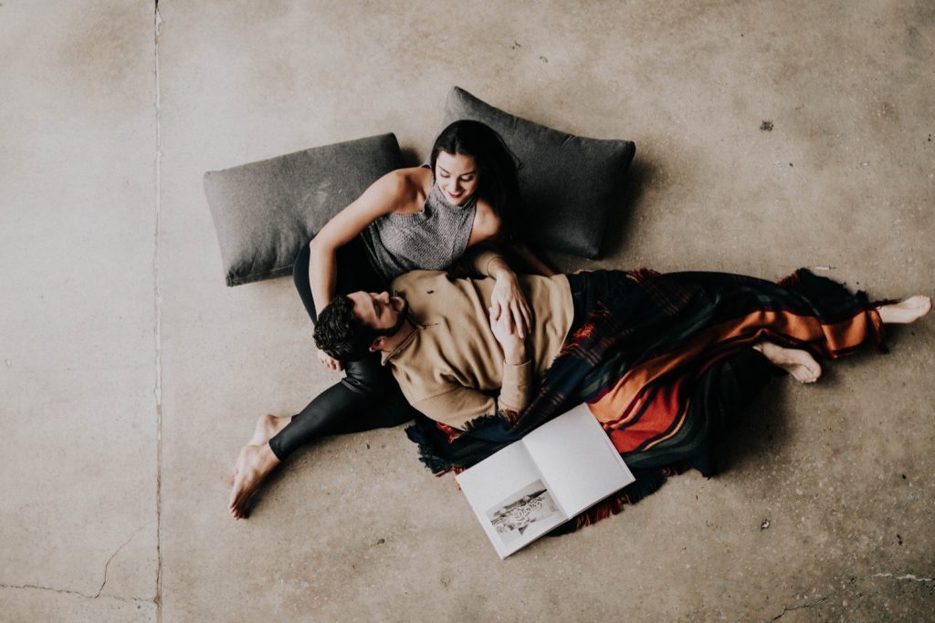 engaged couple snuggling up with each other during their at-home engagement photos