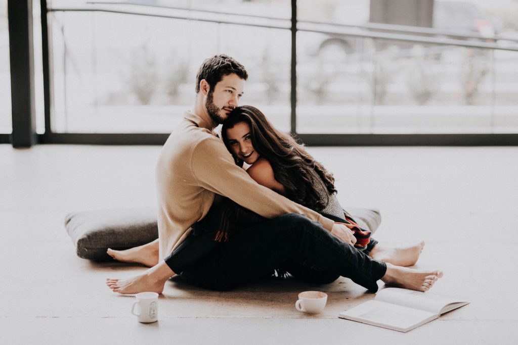 engaged couple drinking coffee and relaxing during their at-home engagement session