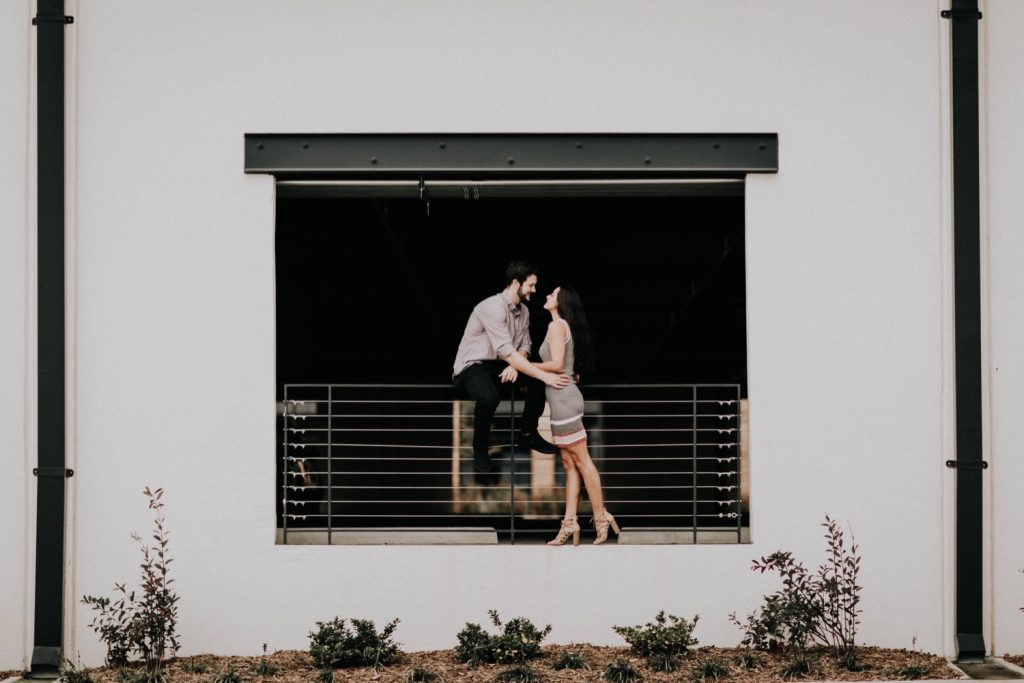 couples photos in a parking deck during their at-home engagement