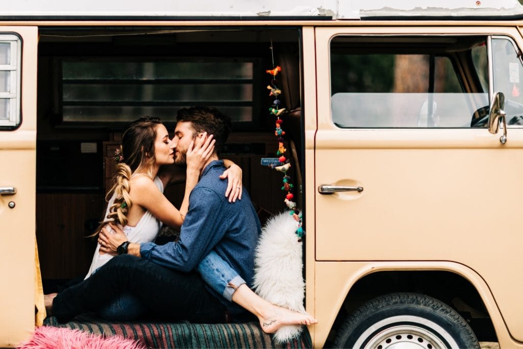 couple kissing and hanging out at their camper van before their Rocky Mountain camper van wedding elopement