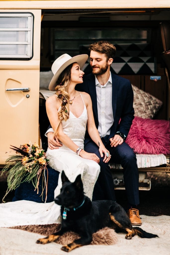 couple hanging out with their dog at their camper van before their Rocky Mountain camper van wedding elopement