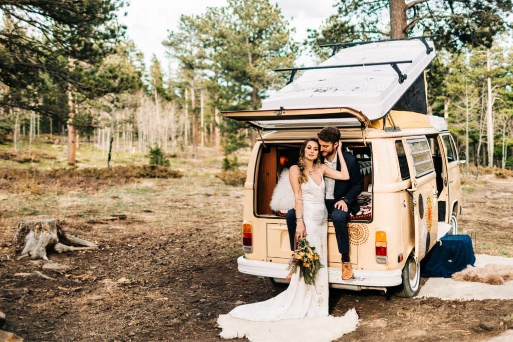 couple hanging out with their dog at their camper van before their Rocky Mountain camper van wedding elopement