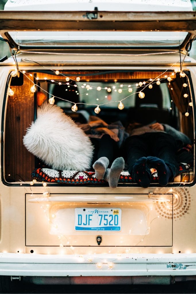 couple snuggling in their van after their camper van elopement wedding in the Colorado Rocky Mountains