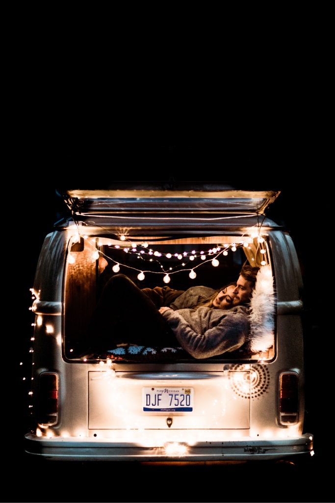 couple curled up in their camper van after their camper van wedding elopement in the Rocky Mountains of Colorado