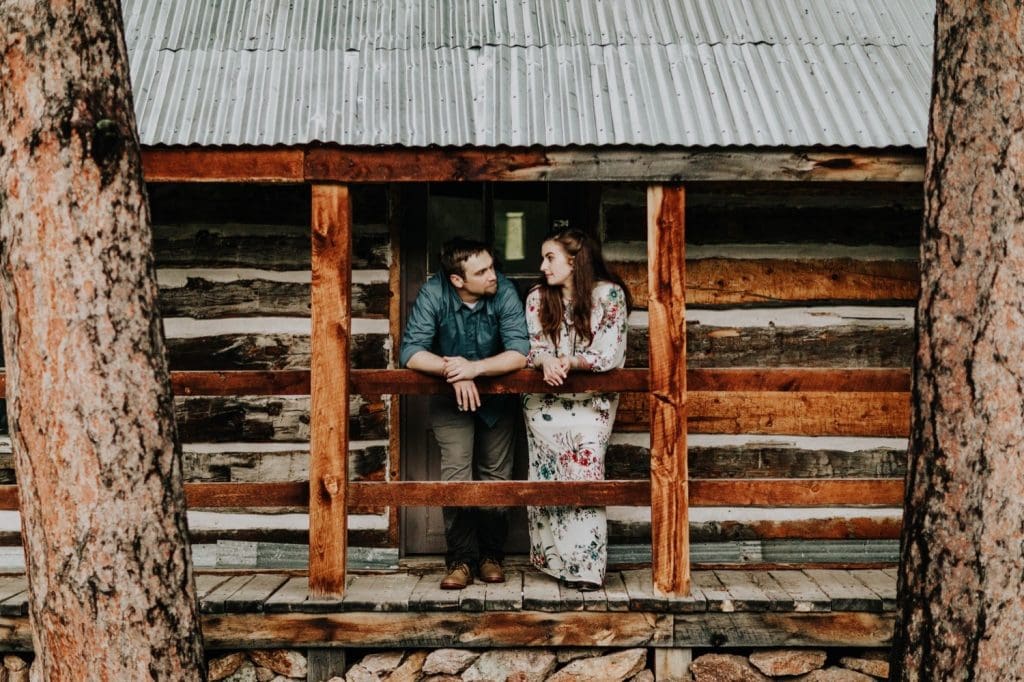 Boulder engagement photos taken outside a cabin in the woods