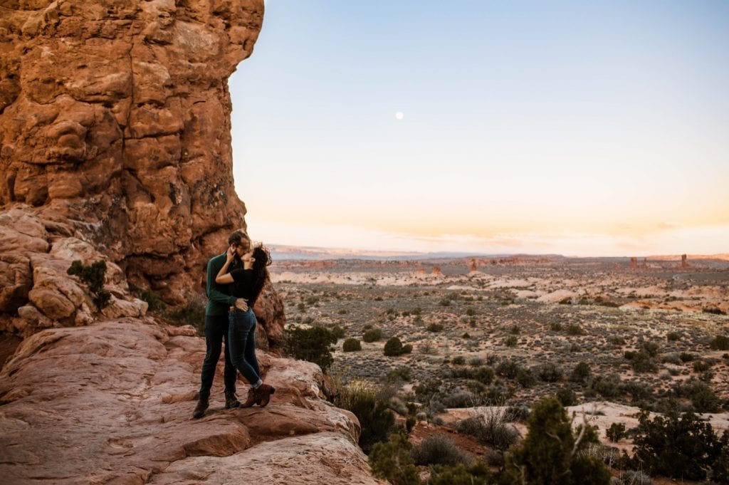 couple kissing at sunrise in Moab Utah