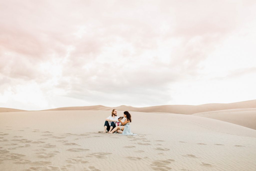 couple with their dog at the sand dunes