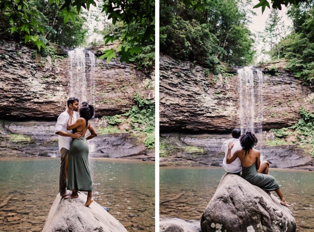engaged couple admiring a giant waterfall during their waterfall engagement session