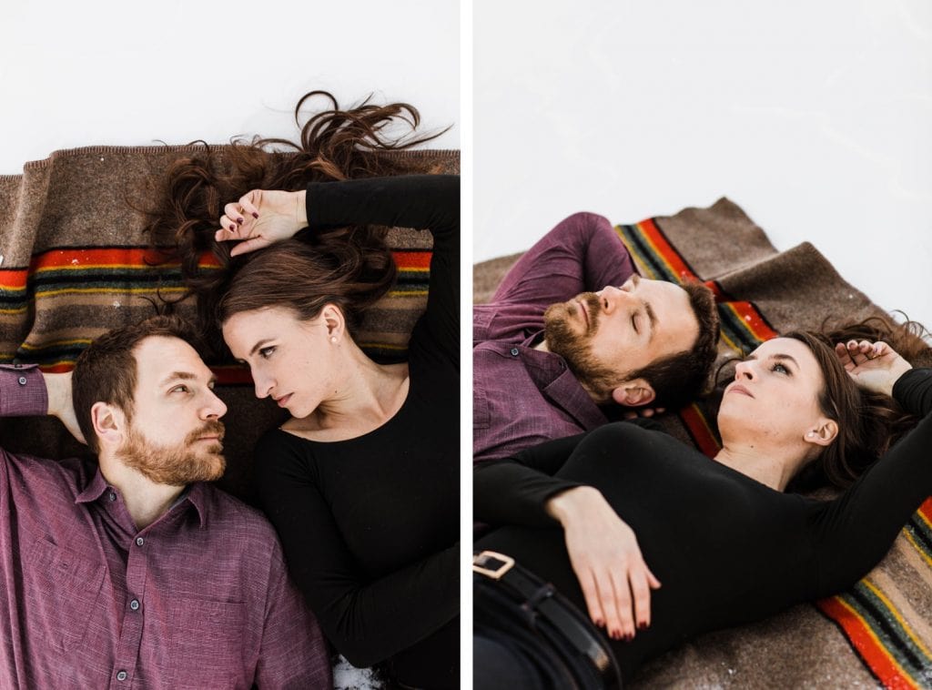couple laying on a Pendleton Yakima blanket during their snowy Colorado engagement session