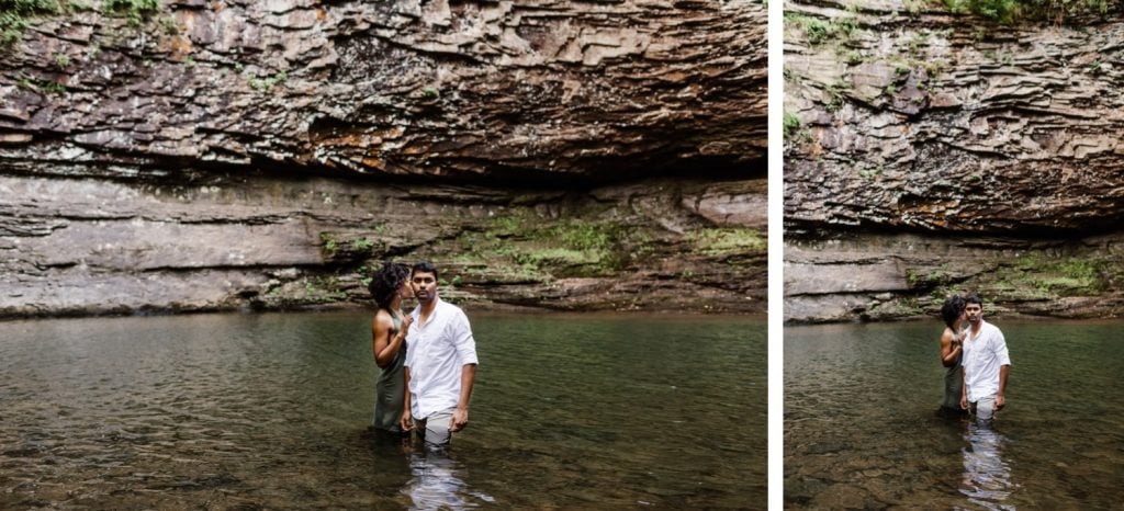 engaged couple in the water beneath a waterfall during their engagement photos