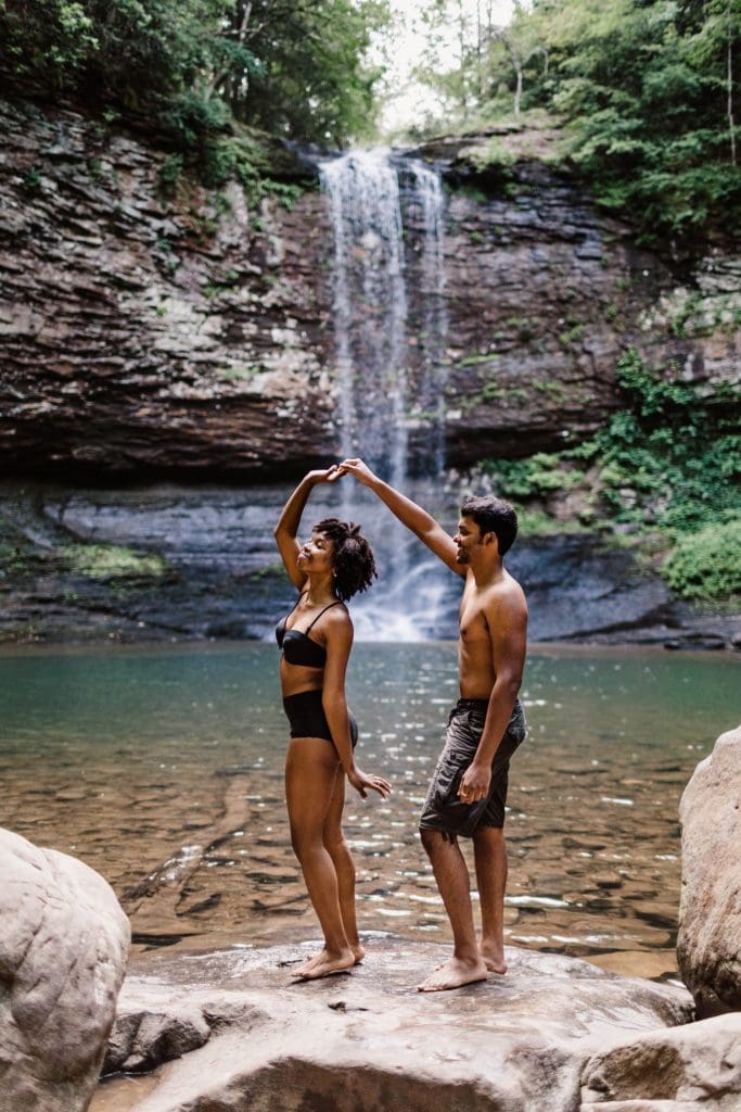 engaged couple dancing during their waterfall engagement session