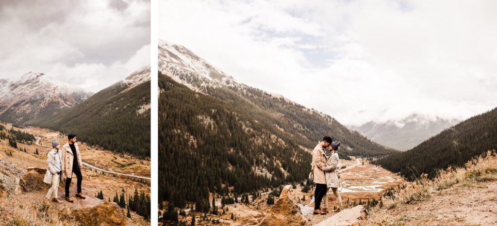 engaged couple standing on a Rocky Mountain pass overlook after their Maroon Bells proposal in Aspen Colorado