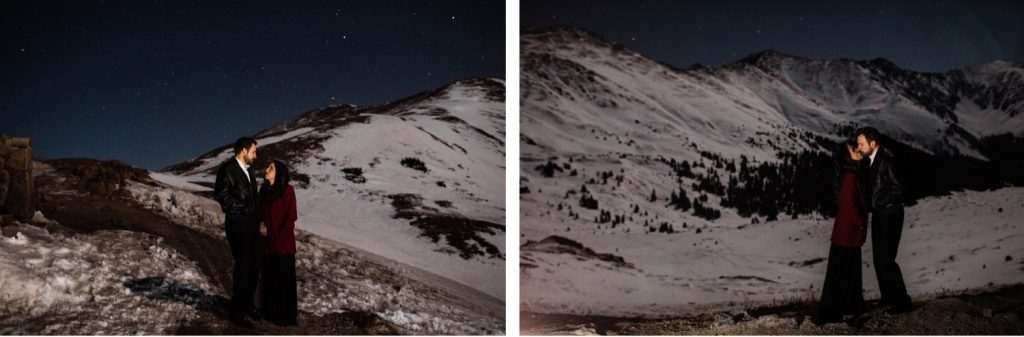 snowy engagement photos of a couple standing underneath a wintry sky full of stars in the Rocky Mountains of Colorado