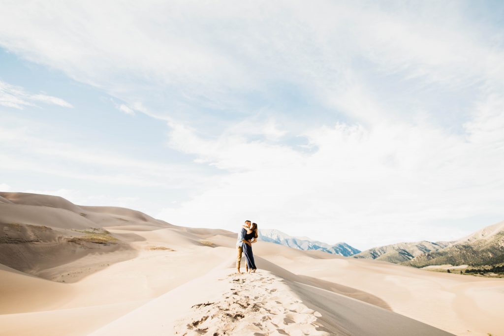 boho flowy engagement outfit inspiration for a sand dunes engagement session