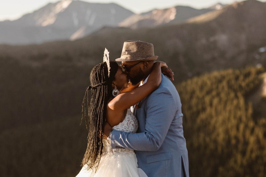 couple sharing first kiss during their self solemnization Colorado ceremony | self uniting marriage photographed by Sheena Shahangian Photography LLC