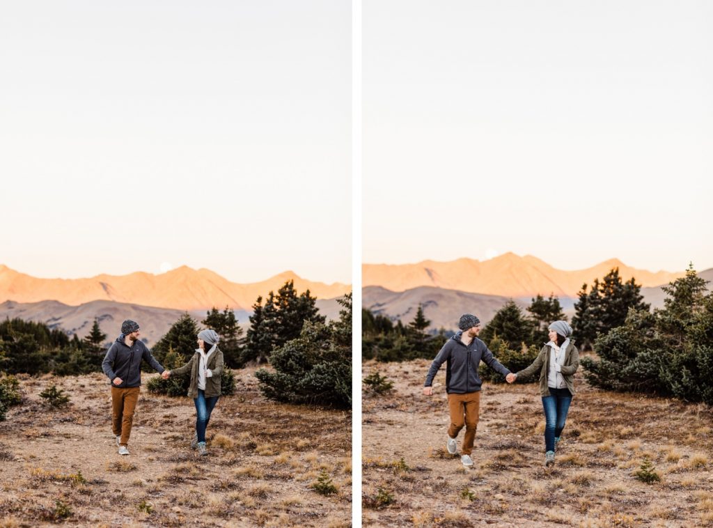 engaged couple running together in the mountains while getting their photos taken during their Rocky Mountain National Park engagement session