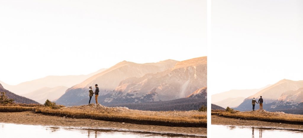 couple hiking around an alpine lake in the Rocky Mountains during their engagement session