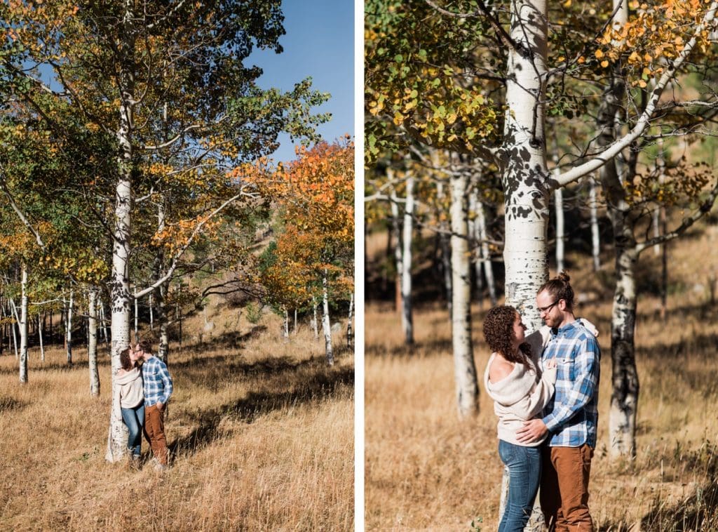 engaged couple standing beneath aspen trees during their Rocky Mountain National Park engagement session in September | Rocky Mountain elopement photographers