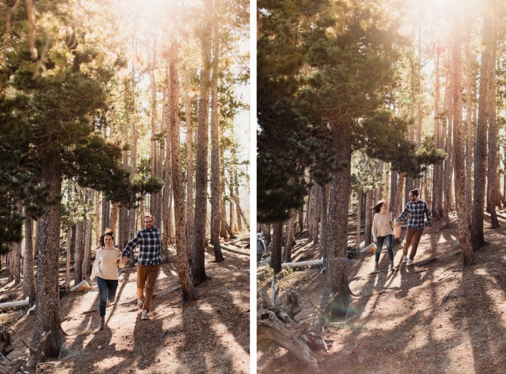 adventurous engaged couple running through the woods at sunrise during their Rocky Mountain National Park engagement photos in Colorado | Rocky Mountain elopement photographers