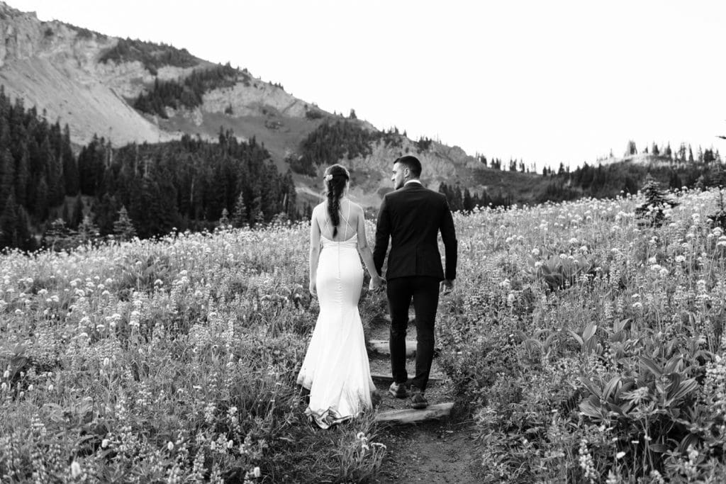 couple hiking during their Mt Rainier elopement | national park elopement photographers in Seattle Washington