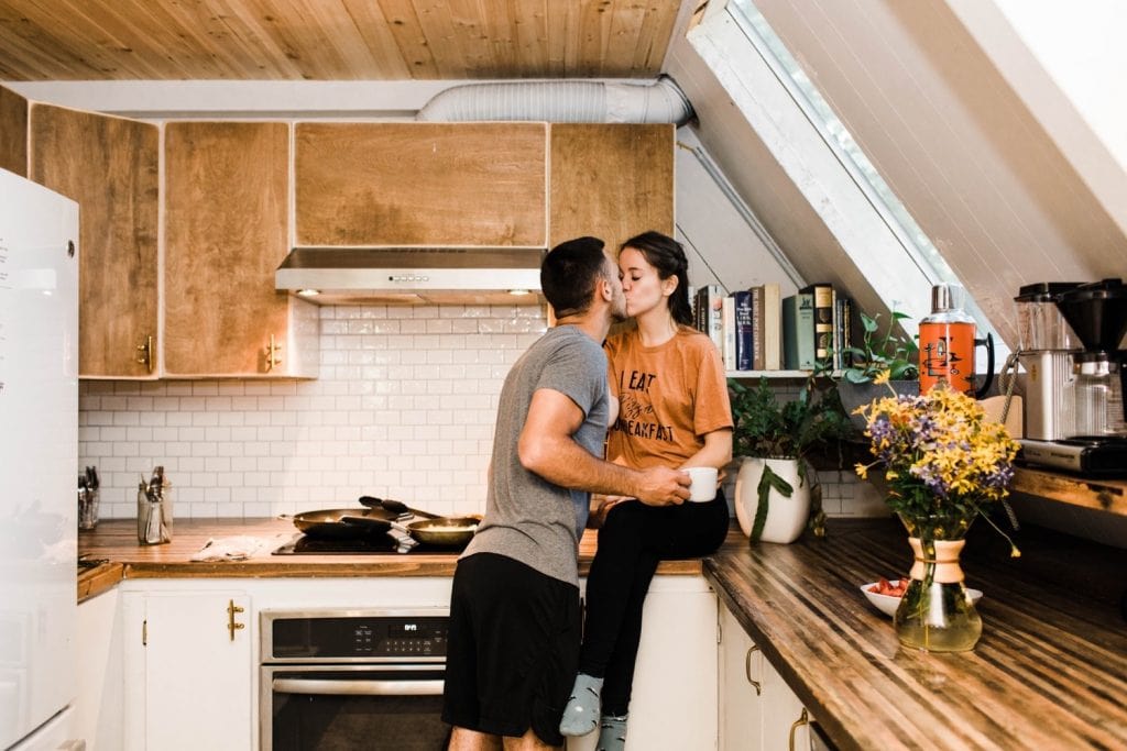 couple cooking breakfast in an a-frame cabin after their Mount Rainier elopement | Washington state elopement adventure wedding in the mountains