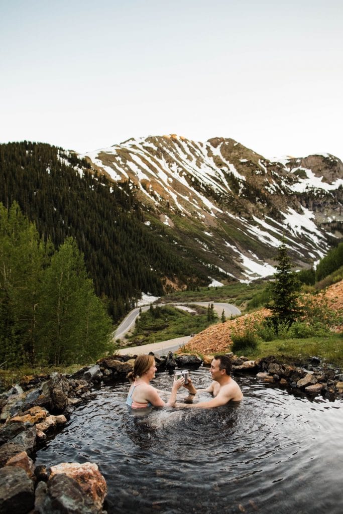 couple drinking cider in a secret hot spring near Telluride Colorado