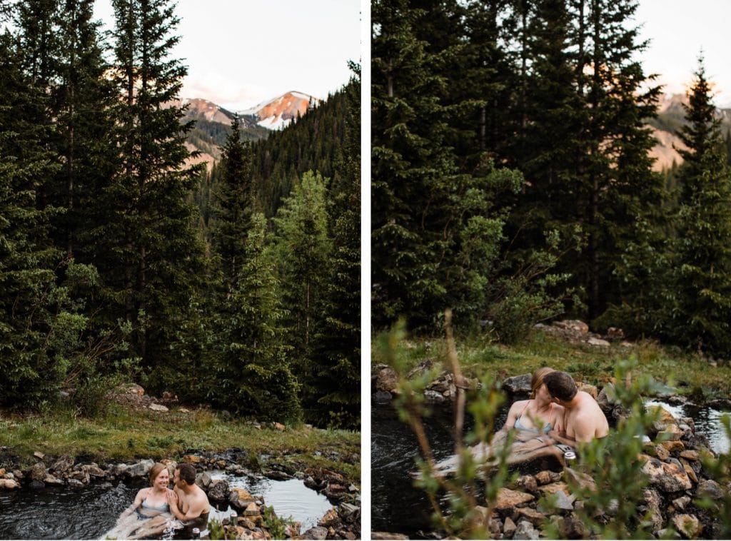 adventurous Colorado couple enjoying the sunset in the San Juan Mountains during their secret hot springs engagement session in Telluride Colorado