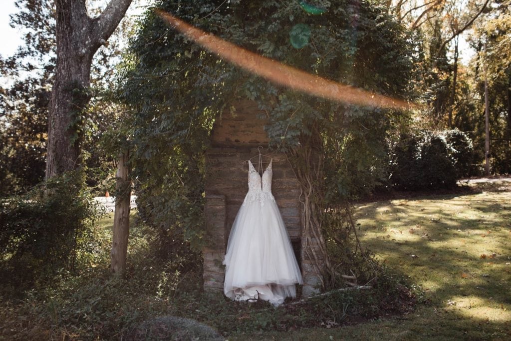 bride's wedding dress hanging up in Dunaway Gardens