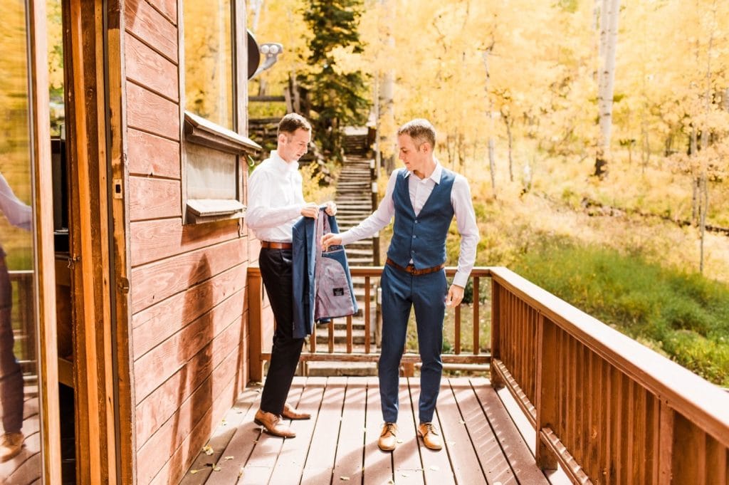 adventurous groom getting ready before his small Telluride wedding at a horse ranch in the San Juan Mountains