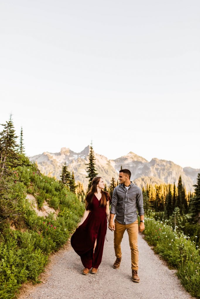 engaged couple walking down a hiking trail in a national park during their engagement photos in Seattle Washington