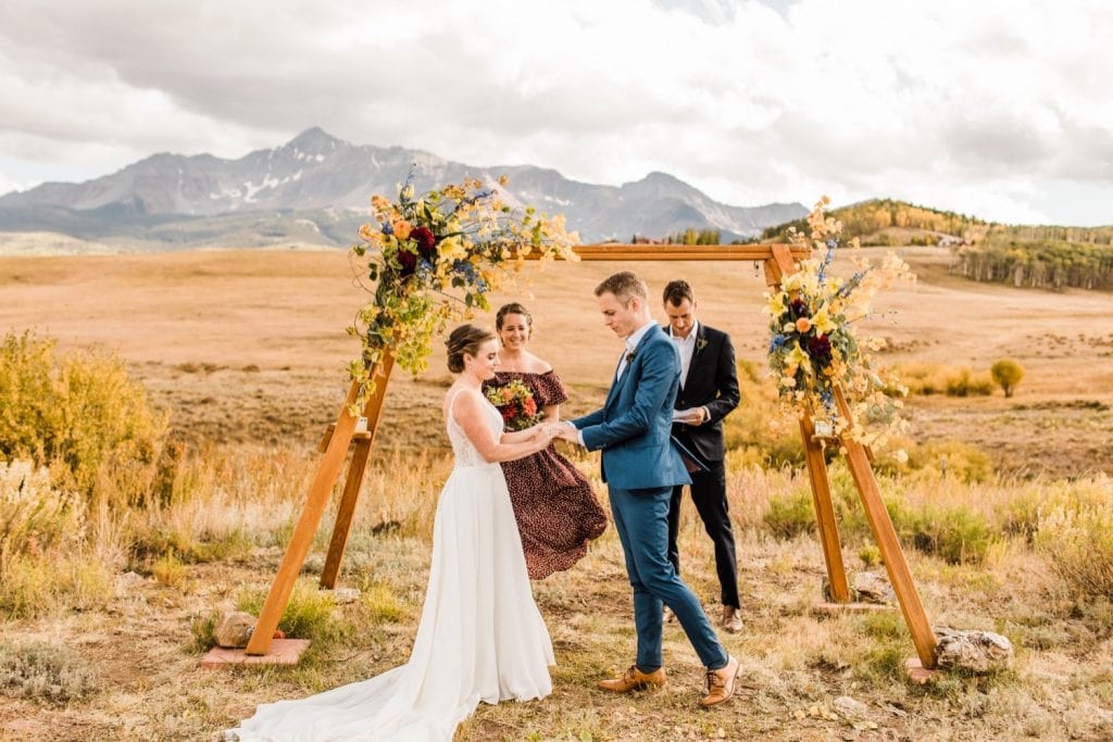 ring exchange during a mountainous Telluride wedding ceremony at a horse ranch on Wilson Mesa