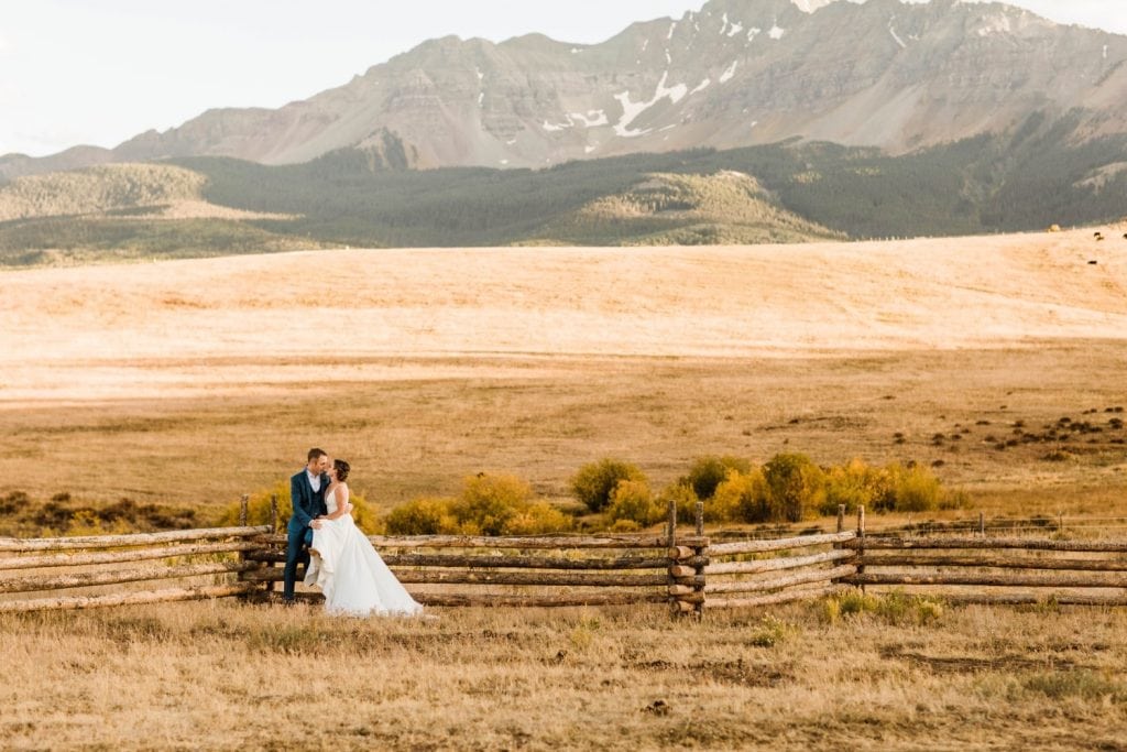 couple sitting together at a Wilson Mesa horse ranch wedding in Telluride | photographed by Telluride wedding photographers