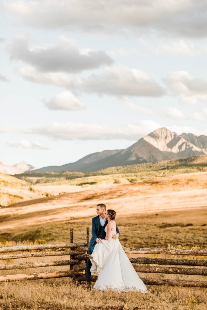 couple sitting together at a Wilson Mesa horse ranch wedding in Telluride | photographed by Telluride wedding photographers