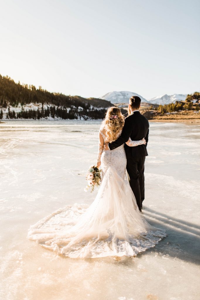 newly married couple standing on a frozen lake down the road from Sapphire Point Overlook