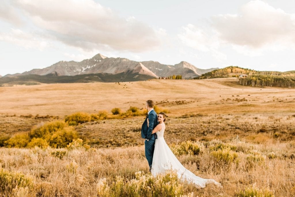adventurous mountain wedding photos of a newly married couple at sunset during their Telluride wedding | image by Telluride wedding photographers