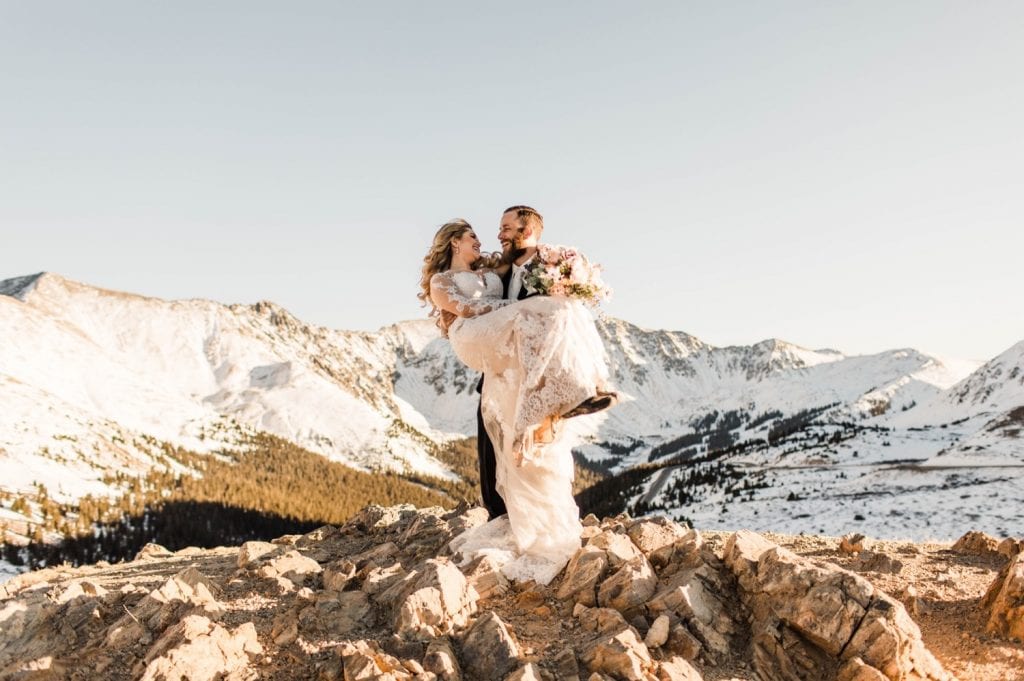 groom holding bride in the mountains after their Sapphire Point wedding in Colorado