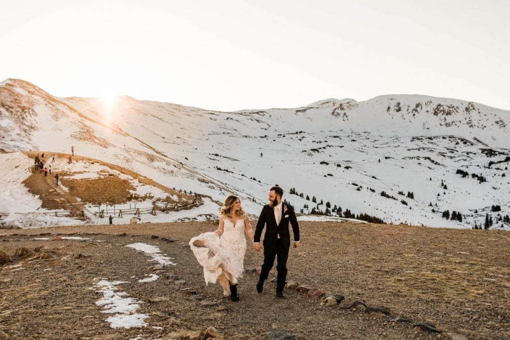 newly married couple running through the Rocky Mountains at sunset after their Sapphire Point Overlook wedding