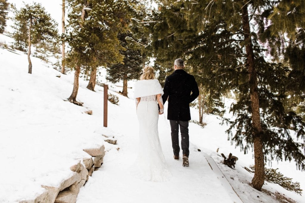 couple hiking during their Sapphire Point elopement in the snow