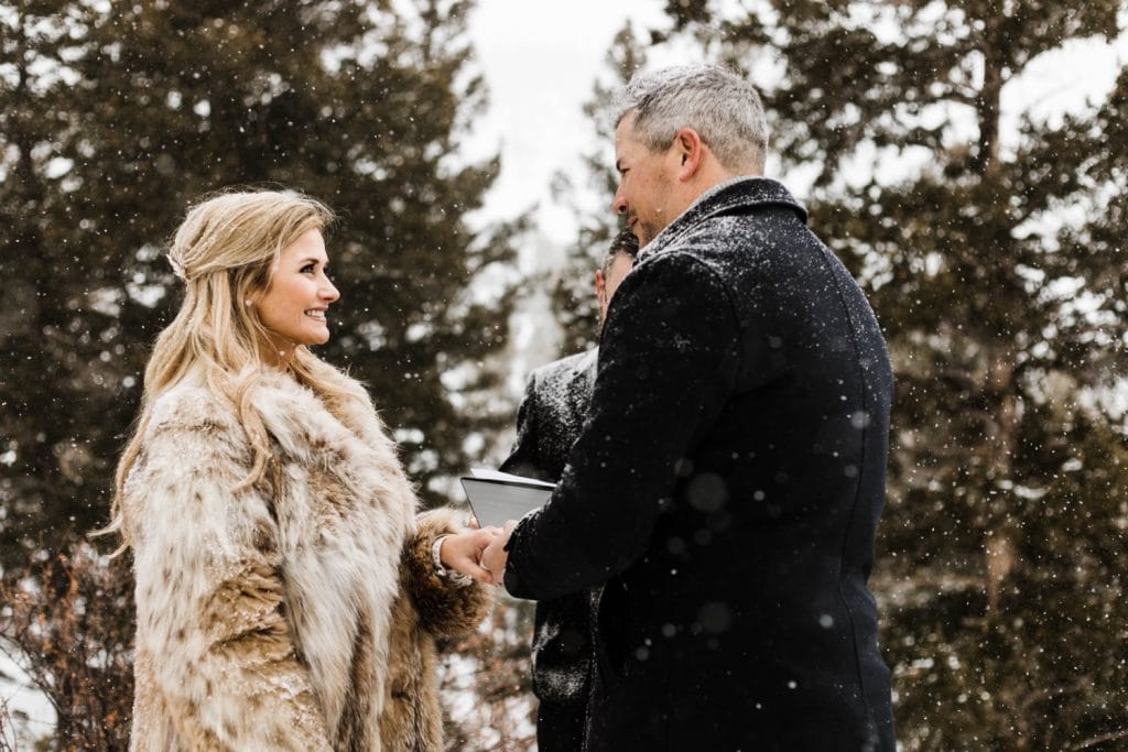 eloping couple exchanging rings during their winter Sapphire Point elopement in Colorado