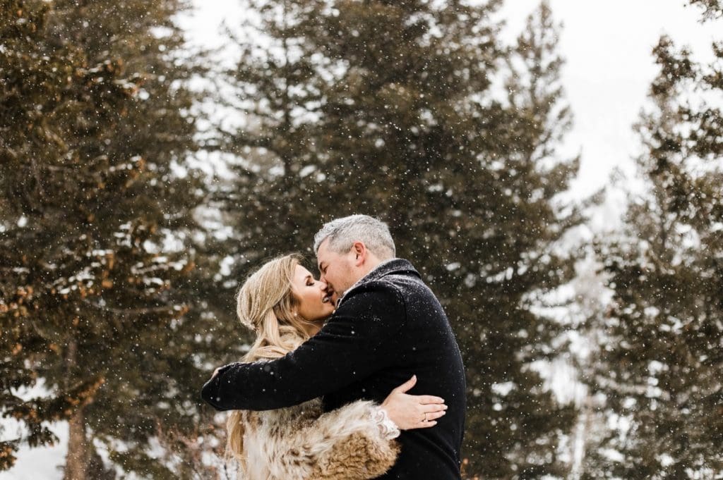 eloping couple sharing their first kiss during their winter Sapphire Point elopement ceremony