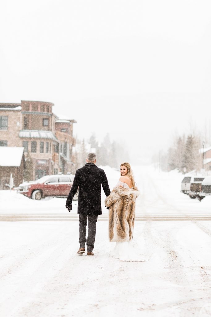 eloping couple walking through downtown Frisco Colorado after they eloped at Sapphire Point Overlook