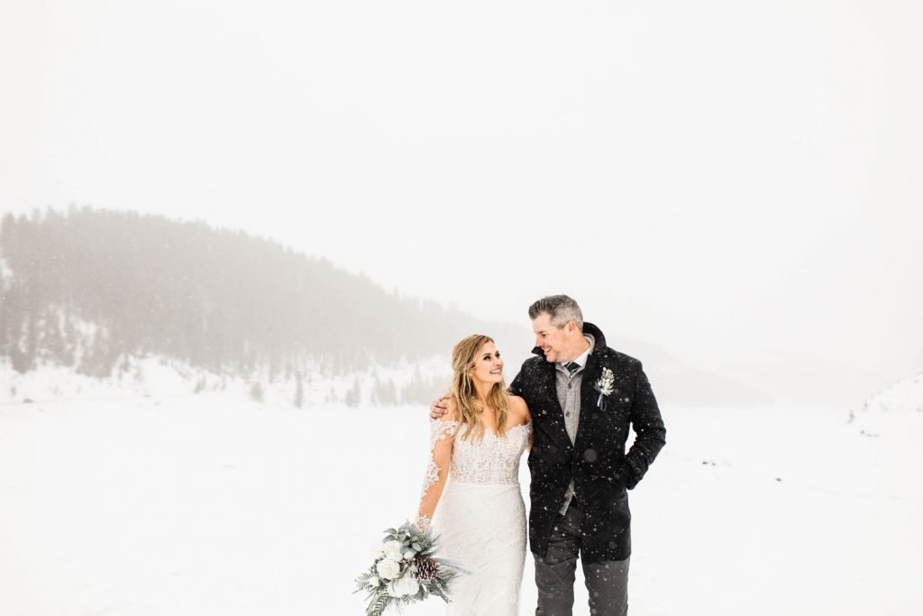 couple walking together in the snowy mountains after they eloped at Sapphire Point Overlook