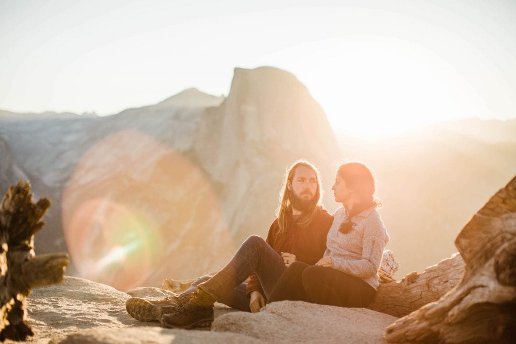 adventure elopement photographers enjoying a hazy sunrise in the mountains together