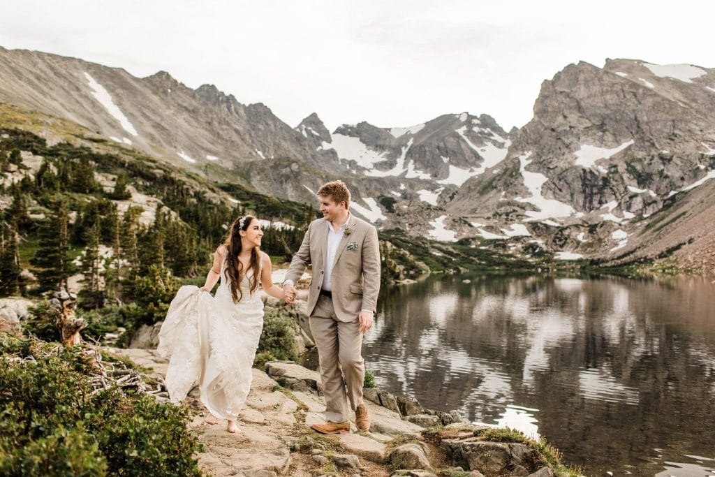 how to elope without offending family | eloping couple hiking through the mountains