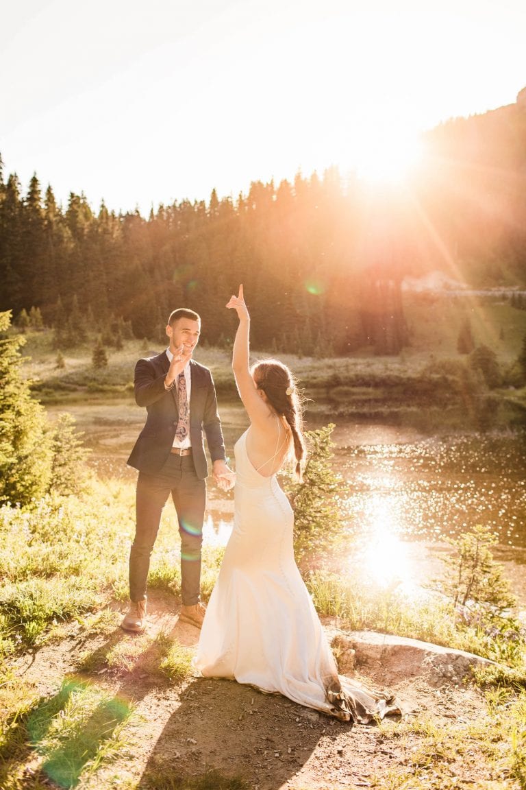 couple's first dance during their Mt Rainier National Park elopement adventure wedding while the sun shines behind them