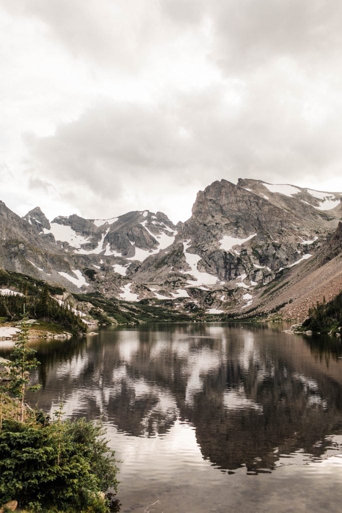 photo of a high alpine lake with snow on it taken by Colorado mountain wedding photographers